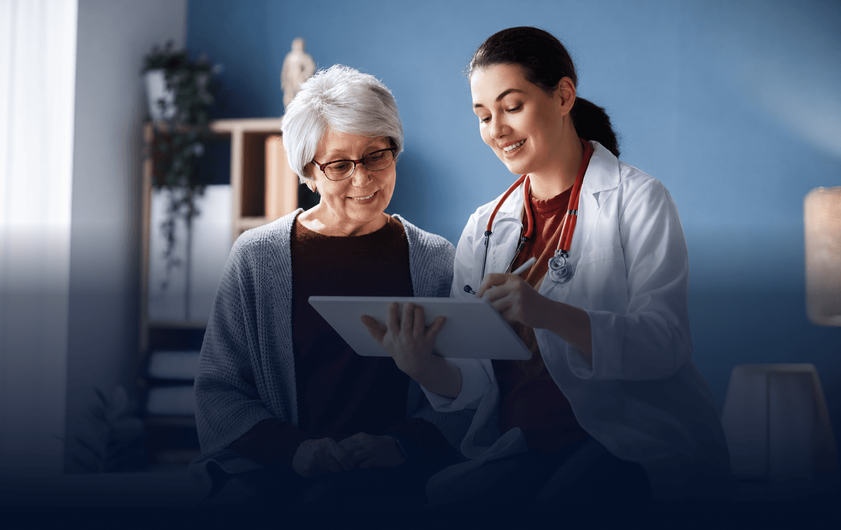 Doctor reviewing a tablet with a senior patient